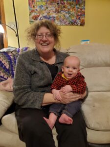 Grandma cuddles with Garrett. 