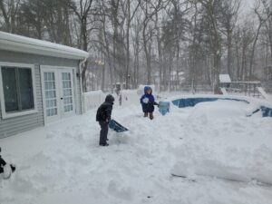 Jarek and Evan shoveling snow on our deck in New Jersey. 