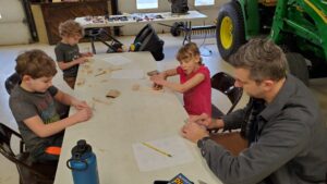 Kids working on their cars after the big cuts. 