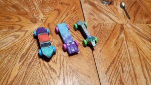 The finished products of the pinewood derby cars. Like most things, we should have started a bit earlier. Megan and I were up late finishing them up with all of the various performance enhancements. We discovered that there is quite the racing community built around pinewood derby competitions. Left to right, Evan's Car, Arya's Car, and Jarek's Car. Evan designed his around a basic car model. Arya went with the wedge, and Jarek wanted his to be like a missile. 