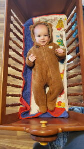 Garrett (6.5 mos) relaxing in the cradle built by his Grandfather. The cradle has been used by all of our children. 