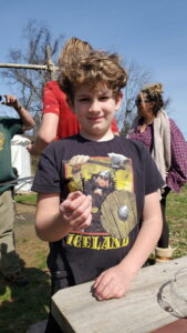 Jarek holding up a nail he made. 