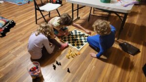 The children learned to play chess and enjoy playing each other. Now in 2023, they have started to play chess online with other people via a chess app on their tablets. 