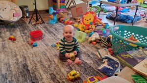 A happy Garrett figuring out his toys!