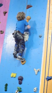 A homeschool rock climbing event. Evan heads up the wall!