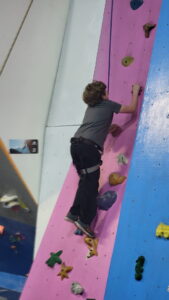 A homeschool rock climbing event. Jarek heads up the wall!