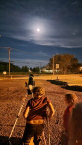 Jarek takes a look at the moon through the telescope. Jarek is on crutches because he injured his knee and needed to stay off it. 