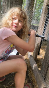 Arya helps cut the fence for the installation of our automatic chicken coop door. Both she and Evan wanted to help with the installation. 