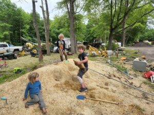 Excavating for rocks in the sand pile. The kids love to dig and build forts. 