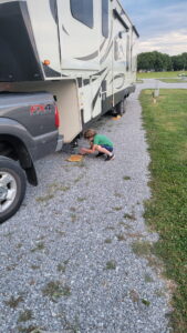 Back from the shop, we packed up and headed out on the road. We drove east to a camp site outside of Sevierville, TN where we would spend the Forth of July weekend. Here, Jarek is helping me set up the jack pads before we setup the RV. 