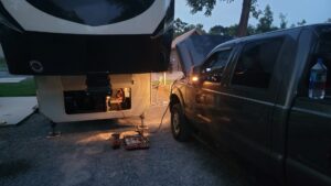 We started having some weird low power issues, mostly noticeable when operating the hydraulics. The hydraulics draw a heavy load on the battery. Troubleshooting revealed that the batteries were not charged. So here I am using the truck to try to top off the on board deep cycle batteries. 