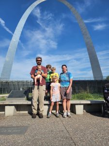 Family picture in front of the arch. 