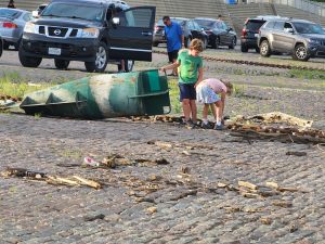 Back alongside the pier, kids explore a channel marker buoy that had washed up on shore. 