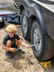 Evan helping loosen and remove lug nuts. 
