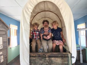 The kids all loaded up in the wagon for their journey west. 