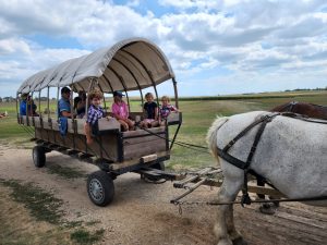 Kids loaded up on the wagon ready to go to school!