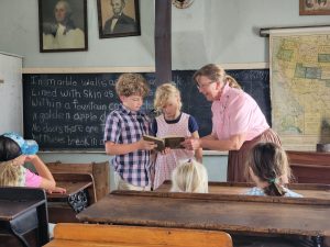Jarek and Arya donned some period clothes and recited a lesson out of a period reader. 
