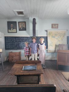 Our three pupils at the front of the classroom for their school photo. 