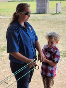 Evan makes rope with the help of one of the staff members. 