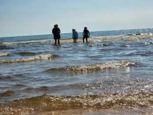 Meagan and the kids walk out into the Lake. 