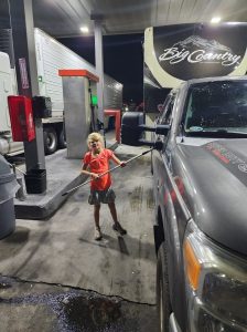 Fueling up at a truck stop. The kids always love to help out and wash the windows when we stop for fuel. 
