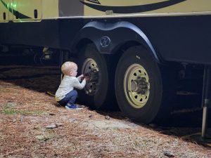 Garrett inspects the tires after we arrive at the RV park to make sure everything is ok!