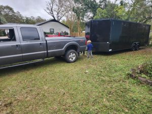 Evan and Jarek help Alan disconnect the new cargo trailer. This trailer would be used to haul our household goods out of NJ in the coming months. 